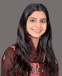 A young woman in a brown sari posing for a photo.